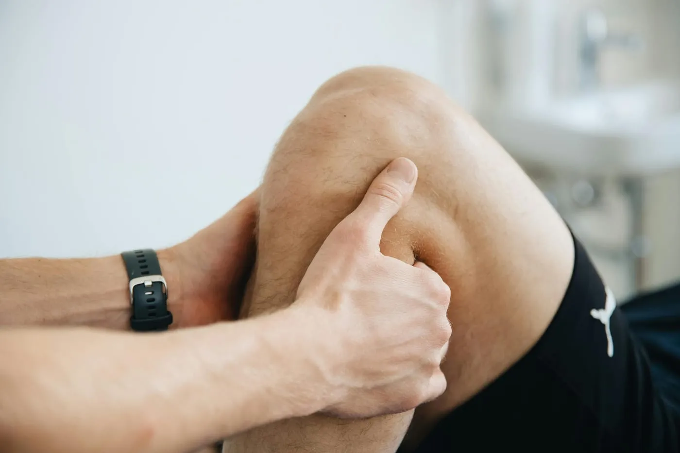 A person clutching a painful knee